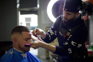 a barber giving someone a low taper fade